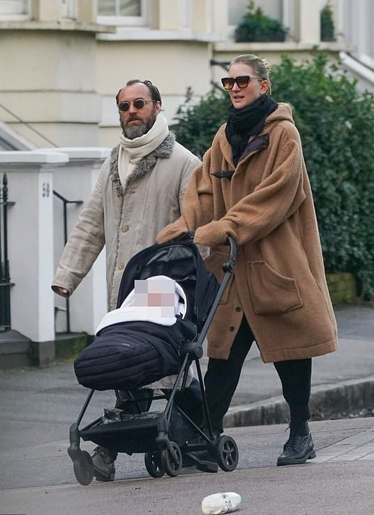 Jude Law debuts ponytail on walk with wife Phillipa Coan and new baby
